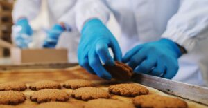 Food Safe HACCP blue nitrile gloves used to removing cookies from oven tray