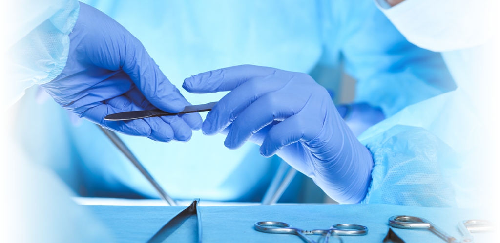 Surgeon passing medical instrument wearing blue gloves
